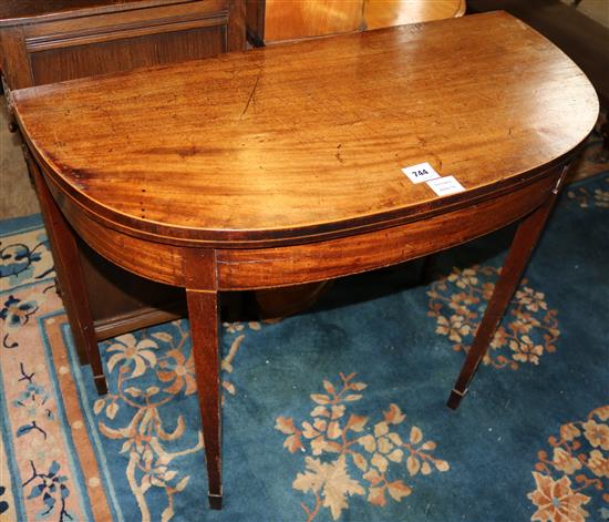 George III inlaid mahogany D shaped card table(-)